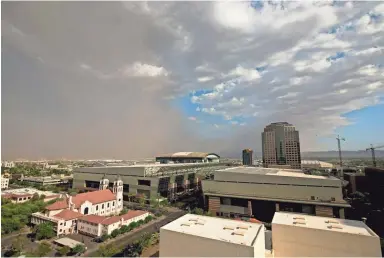  ?? DAVID WALLACE/THE REPUBLIC ?? A dust storm passes through downtown Phoenix Thursday afternoon, shortly after the temperatur­e reached 115 degrees.