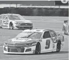  ?? TERRY RENNA/AP ?? Chase Elliott (9) leads a pack of four cars through Turn 3 in Sunday’s race.