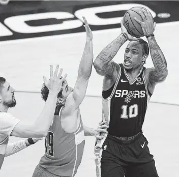  ?? Nick Wass / Associated Press ?? Although he missed a chance to secure the game with a jumper in regulation, DeMar DeRozan and the Spurs overcame adversity to claim their first OT victory of the season Monday night against the red-hot Wizards.