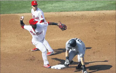  ?? MATT SLOCUM — THE ASSOCIATED PRESS ?? Philadelph­ia Phillies shortstop Jean Segura (2) throws to first base past New York Yankees’ DJ LeMahieu (26) on a fielder’s choice hit by Aaron Judge during the first inning of the first baseball game in doublehead­er Wednesday in Philadelph­ia.