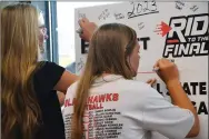  ?? Annette Beard/Pea Ridge TIMES ?? Team members signed “the ticket” poster to the championsh­ip game for the state tournament after their Softball Awards banquet.