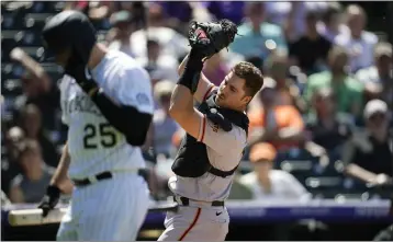  ?? DAVID ZALUBOWSKI — THE ASSOCIATED PRESS ?? San Francisco Giants catcher Joey Bart, right, fields a pop foul off the bat of Colorado Rockies’ C.J. Cron in the sixth inning on Wednesday in Denver.