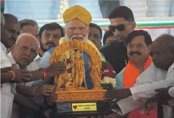  ?? GETTY IMAGES ?? Prime Minister Narendra Modi is gifted an idol of the Hindu god Rama during an election campaign rally in Mysuru on April 14.