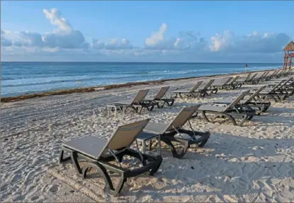  ?? Victor Ruiz/Associated Press ?? Lounge chairs fill an empty beach in Cancun, Mexico on June 11.