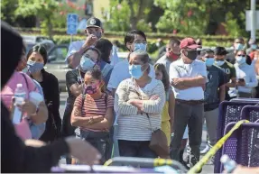  ?? CLIFFORD OTO/USA TODAY NETWORK ?? Hundreds line up for free COVID-19 testing July 3 in the parking lot of Rancho San Miguel Market in Lodi, Calif.