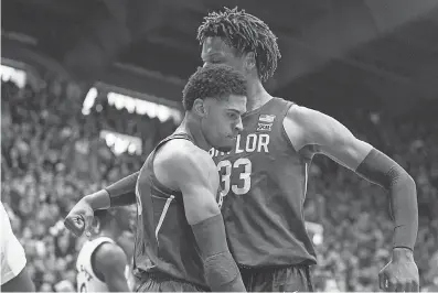  ?? JAY BIGGERSTAF­F/ USA TODAY SPORTS ?? Baylor guard MaCio Teague, left, celebrates with forward Freddie Gillespie after scoring in a victory against Kansas last Saturday at Allen Fieldhouse.