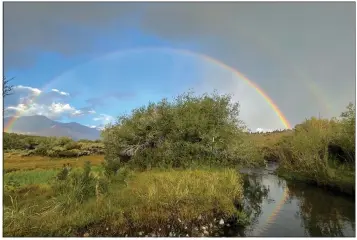  ?? Photo by Wendilyn Grasseschi ?? A double rainbow over Convict Creek is not only beautiful, but a sign of one of the least fire-dominated and smoky summers in years. At least some more monsoon moisture likely to stay in the forecast over the next few weeks.