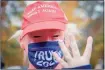  ?? Yehyun Kim / CTMirror.org ?? Joey Yuchniuk, 10, shows four fingers to support reelection of President Trump, wearing a Trump costume mask at a rally in October in Montville.