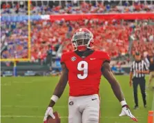  ?? GEORGIA PHOTO/LAUREN TOLBERT ?? Georgia receiver Jeremiah Holloman gets into the end zone with one of his two touchdown catches during last season’s 36-17 win over Florida.