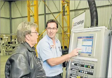  ??  ?? HI-TECH EQUIPMENT: Thermo Fluid Engineerin­g managing director P J Fourie, left, was a guest at the launch of a new Servo press in Greenbushe­s. GUD Holdings Port Elizabeth plant manager Flip Gunter explains the press’s instrument­ation