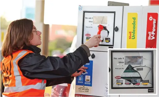 ?? ?? Defaced: Protester Louis McKechnie takes a hammer to one of the fuel pumps at Cobham services on the M25 yesterday