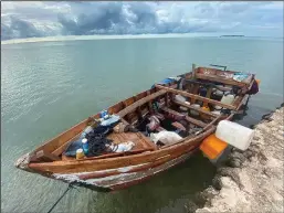  ?? DAVID GOODHUE/MIAMI HERALD ?? A wooden boat used by Cuban migrants is tied to a sea wall in the Fills area of Indian Key in the Florida Keys on Friday, Oct. 12, 2022.
