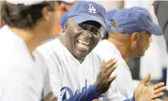  ??  ?? Former Los Angeles Dodgers outfielder ‘‘Sweet’’ Lou Johnson laughs during an old-timers game in 2011.