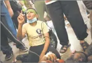  ?? MANU BRABO/AP PHOTO ?? An Egyptian boy prays beside his father, a supporter of ousted President Mohammed Morsi, injured Saturday during clashes with security forces. The father and son were in a field hospital in Cairo.