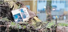  ?? DAVID MCFADDEN THE ASSOCIATED PRESS ?? Family photos rest among debris after flooding in Ellicott City, Md. The former mill town had a destructiv­e storm less than two years ago.