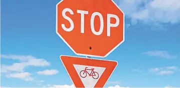  ??  ?? A proposed “Idaho stop” rule for Santa Fe would allow bicyclists to treat stop signs like yield signs.