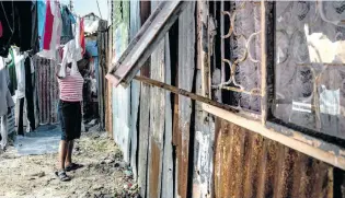  ?? ?? The Mgogwana’s house is slowly sinking into the ground. Its floor level is now below the walkway level next to it. This means water comes rushing through the house when it rains. The family does not have money to move or rebuild their dwelling. Photo: Newton Stanford