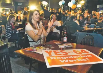  ?? BRENNAN LINSLEY, AP ?? Amanda Jetter celebrates with others attending an Amendment 64 watch party in Denver.