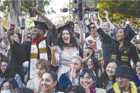  ?? Chris Torres/The SIgnal ?? Graduating students begin to dance before their names are called on stage during the California Institute of the Arts graduation ceremony at the campus courtyard in Valencia on Friday.