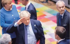  ?? PHOTO:REUTERS ?? CHALLENGES AHEAD: British Prime Minister Boris Johnson, German Chancellor Angela Merkel and French President Emmanuel Macron at the European Union leaders’ summit in Brussels