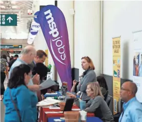  ??  ?? Applicants chat with potential employers during a jobs fair in Minneapoli­s last month. DAVID ZALUBOWSKI/AP