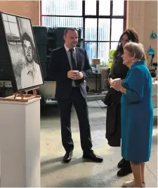  ??  ?? Mary Claire O’Malley admiring a portrait of her granduncle Michael Collins with Friends of Sligo Gaol’s David McLoughlin. Also present was Artist in Residence Emma Stroude, who painted the piece.