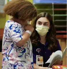  ?? Sebastian Foltz/Post-Gazette photos ?? Siah Holland-Stewart, 12, picks out something to color as she talks with volunteer Isabella Valentino in one of the play areas at UPMC Children’s Hospital in Bloomfield.