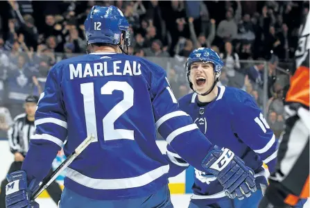  ?? BRUCE BENNETT/GETTY IMAGES ?? Toronto Maple Leafs’ Patrick Marleau celebrates his overtime game-winning goal against the Boston Bruins as he is joined by Mitch Marner, at the Air Canada Centre, on Nov. 10.