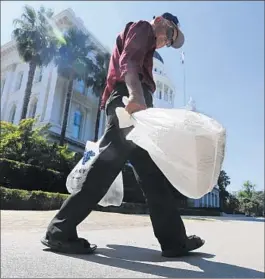  ?? Rich Pedroncell­i
Associated Press ?? BY LAST SUMMER, when Sacramento acted on the bag ban, more than 125 California cities and counties had their own prohibitio­ns on the books.