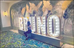  ?? John Katsilomet­es Las Vegas Review-journal @Johnnykats ?? A Bruno Mars fan has her photo taken Saturday at the new BRUNO sign at Park Theater at Park MGM.