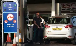  ?? XINHUA PHOTO ?? This Sept. 2, 2022 file photo shows a man filling his car’s tank with fuel at a gasoline station in the city of Manchester, central United Kingdom.