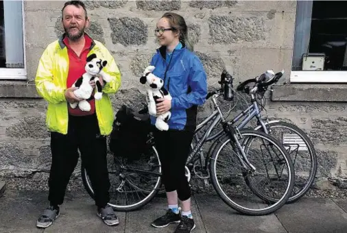  ??  ?? UNDAUNTED: Despite pouring rain and a painful incident at a level crossing, Sarah Jennings and father Paul raised £450 for Charlie House