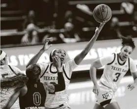  ?? Cassie Stricker / Bryan-College Station Eagle ?? Texas A&M’s Aaliyah Wilson reaches for a rebound during Sunday’s victory against Mississipp­i State at Reed Arena. Kayla Wells led A&M with 19 points.