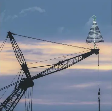  ??  ?? A tree-rrific picture of a Christmas tree propped 200ft in the air – on the top of a massive crane. The incredible metal tree stands 13 feet tall and has become a much-loved focal point in Burntislan­d, Fife