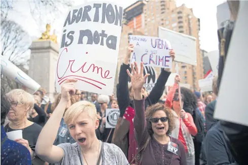  ??  ?? TRUMP BACKLASH: Kayla Forshey, left, participat­es in a rally to condemn Republican presidenti­al candidate Donald Trump’s remarks about women and abortion, on Thursday in New York.