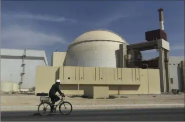  ?? MEHR NEWS AGENCY — THE ASSOCIATED PRESS FILE ?? A worker rides a bike in front of the reactor building of the Bushehr nuclear power plant in 2010.