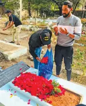  ?? PTI ?? Mohammed Siraj prays at his father Md Ghouse’s grave after his arrival in Hyderabad on Thursday. —