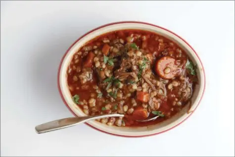  ?? TODD COLEMAN VIA AP ?? Brisket and barley soup cooked vegetables from the brisket and saute for 2 more minutes until the barley is nicely coated with the oil and toasty looking. pretty tender.
Turn the heat to high, add the chopped brisket and any chopped cooked carrots or...