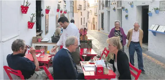  ?? RICK STEVES, RICK STEVES’ EUROPE ?? A cobbled street in Arcos de la Frontera serves as an alfresco dining spot.