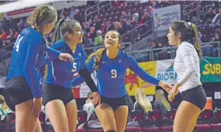  ?? PHOTOS BY DYLAN BIDA/RIO GRANDE SUN ?? St. Michael’s defensive specialist Angela Griego, second from right, talks with setter Miquela Martinez, second from left, outside hitter Amanda Marbourg, left, and libero Darian Ortiz during a Class 3A semifinals match in the Santa Ana Star Center on Friday. The Lady Horsemen swept Las Vegas Robertson to advance to Saturday’s state title match.