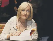  ??  ?? 0 JK Rowling signs copies of Harry Potter and the Deathly Hallows, which she completed on this day in 2007