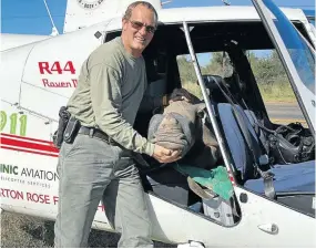  ?? Picture: Nico Jacobs ?? Nico Jacobs of Rhino 911 with four-month-old Jessie, evacuated on April 30 after her mother was poached in the North West.