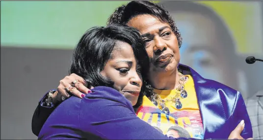  ?? John Bazemore The Associated Press ?? Bernice King, daughter of civil-rights leader Martin Luther King Jr., right, is embraced by her cousin Angela Farris Watkins as she speaks about her brother Dexter Scott King on Tuesday. Dexter died Monday at 62 after battling prostate cancer.