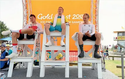  ?? PHOTOS: GETTY IMAGES ?? Hamish Bond, right, takes his place in the bronze medallist’s seat, alongside English runner-up Harry Tanfield, left, and Australian winner Cameron Meyer after the individual time trial.