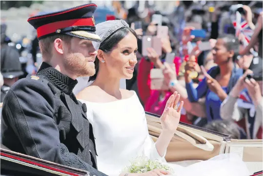  ?? FRANK AUGSTEIN,THE ASSOCIATED PRESS ?? Prince Harry and his bride, Meghan Markle, ride in a carriage after their wedding ceremony at Windsor Castle in May. Prince Harry and his wife, the Duchess of Sussex, are expecting their first child in spring 2019.