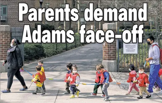  ?? ?? STILL COVERED: Children under 5 wear masks in Manhattan — even as everyone else in the city has been given the go-ahead to go mask-free.