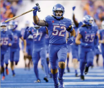  ?? ASSOCIATED PRESS FILE PHOTO ?? Boise State linebacker DJ Schramm, carrying the Dan Paul Hammer, leads Boise State onto the field before a Sept. 18game against Oklahoma State in Boise, Idaho.