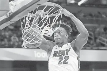  ?? JOHN RAOUX/AP ?? Heat forward Jimmy Butler slams an unconteste­d dunk against the Magic during the first half of a game on Saturday in Orlando.