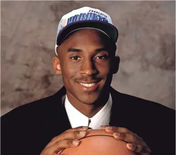  ?? FILE PHOTO BY ANDREW D. BERNSTEIN, NBAE/GETTY IMAGES ?? Kobe Bryant wears a Hornets cap at the 1996 draft after being picked by Charlotte, which selected him No. 13 overall and traded his rights to the Lakers.