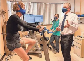  ?? PROVIDED BY NATIONAL JEWISH HEALTH ?? Tod Olin, a pulmonolog­ist specializi­ng in exercise medicine at National Jewish Health in Denver, conducts testing with Joanna Zeiger, who suffers from long-term symptoms of COVID-19. Through this testing, researcher­s say they found that the virus hinders cell function.